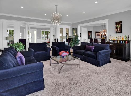 a living room with blue couches and a table at Somerset - A Private Retreat in Niagara on the Lake