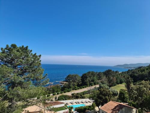 a view of the ocean from a house at Residence Canella in Sari Solenzara
