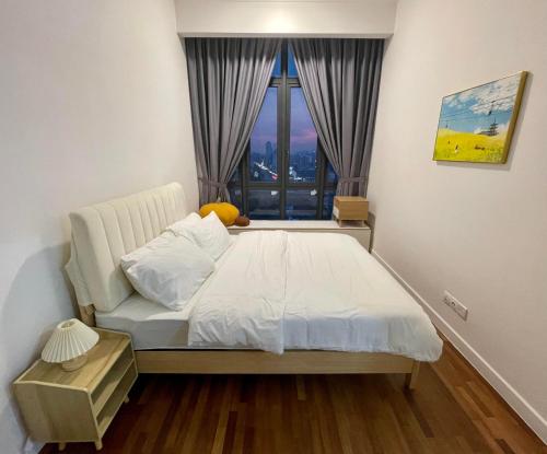 a bedroom with a bed and a large window at Luxury Studio Apartment with KL Breathtaking View in Kuala Lumpur