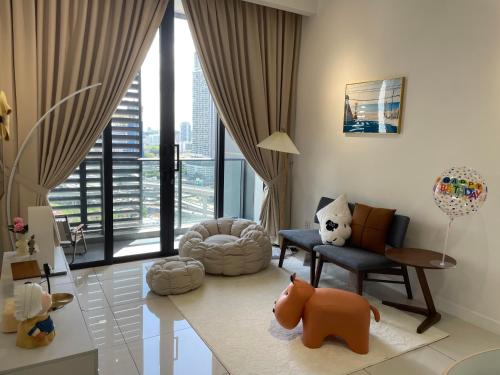 a living room filled with furniture and a large window at Luxury Studio Apartment with KL Breathtaking View in Kuala Lumpur