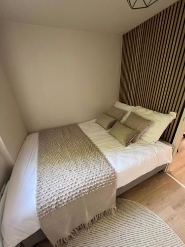 a bed with white sheets and pillows in a bedroom at Haus Leopold in Breiten