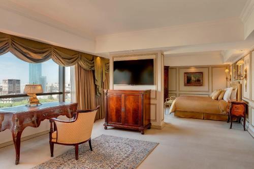a bedroom with a desk and a bed and a television at Park Tower, A Luxury Collection Hotel, Buenos Aires in Buenos Aires