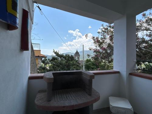 a bench sitting on a balcony with a view at La Casa Del Borgo Cavallaro in Gaggi