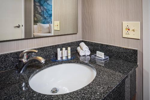 a bathroom counter with a sink and a mirror at Courtyard by Marriott Riverside UCR/Moreno Valley Area in Riverside