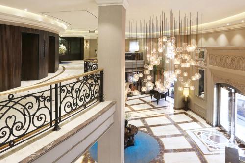 a lobby with a staircase and a chandelier at Four Points by Sheraton Lahore in Lahore
