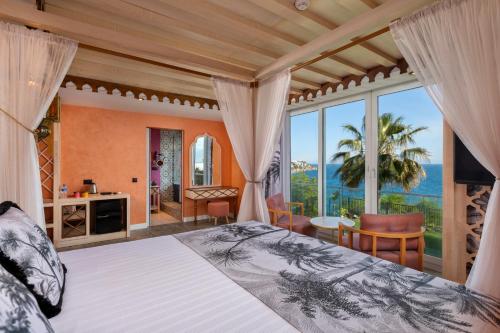 a bedroom with a bed and a view of the ocean at Afflon Hotels Sea Hill Concept in Antalya