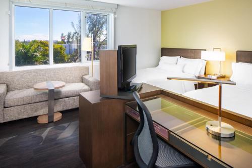 a hotel room with a bed and a tv at Element Miami International Airport in Miami