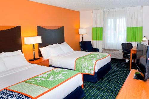 a hotel room with two beds and a television at Fairfield Inn by Marriott Forsyth Decatur in Forsyth