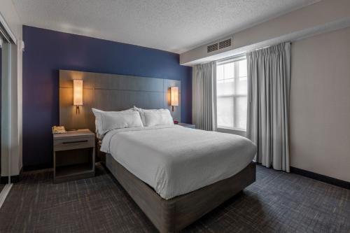 a hotel room with a large bed and a window at Residence Inn Columbus Easton in Columbus
