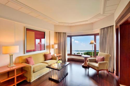 a living room with a couch and two chairs at Hyderabad Marriott Hotel & Convention Centre in Hyderabad
