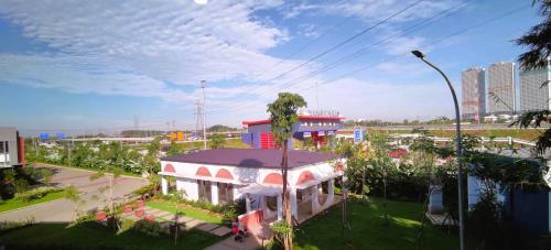 a building with a palm tree next to a street at Freja House @ Central BSD in Samporo