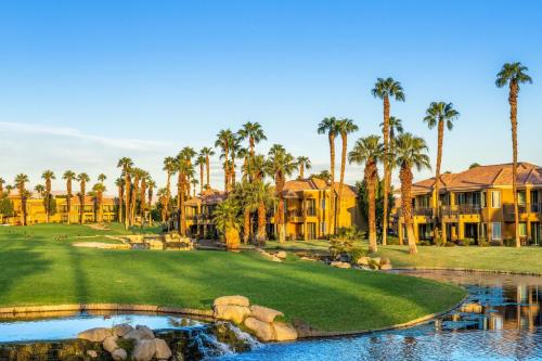 a golf course with palm trees and a resort at Marriott's Desert Springs Villas II in Palm Desert