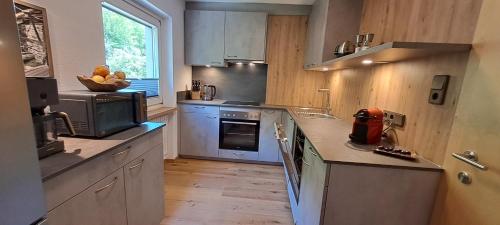a kitchen with blue cabinets and a counter top at Haus Tirol Appartements in Ried im Oberinntal