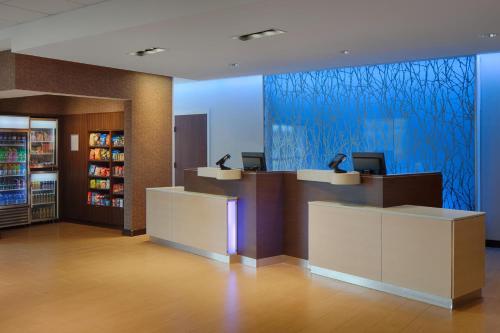 a lobby of a store with two reception desks and a blue wall at Fairfield Inn & Suites by Marriott Columbus Airport in Columbus