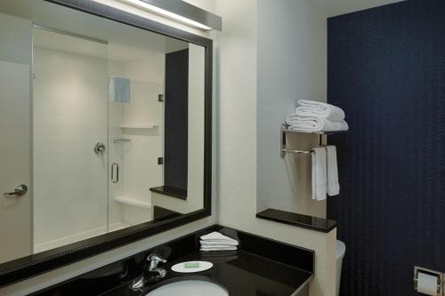 a bathroom with a sink and a mirror at Fairfield Inn & Suites by Marriott Columbus Airport in Columbus