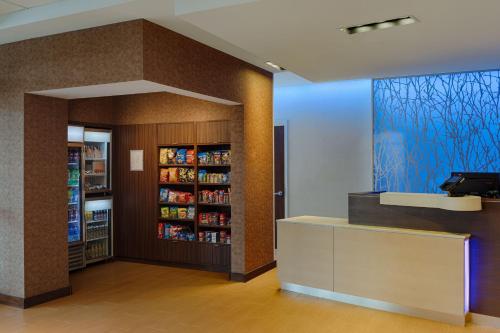 a grocery store with a book shelf with soda bottles at Fairfield Inn & Suites by Marriott Columbus Airport in Columbus