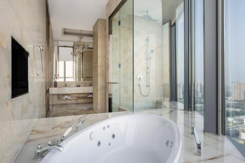 a large bathroom with a tub and a shower at Shunde Marriott Hotel in Shunde