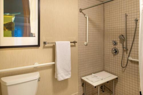a bathroom with a white toilet and a shower at Residence Inn Gainesville I-75 in Gainesville