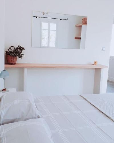 a white room with a table and a mirror at ZEN in Sifnos