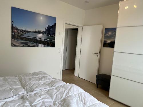 a bedroom with a bed and a picture on the wall at Ferienhaus Enjoy in Büsum