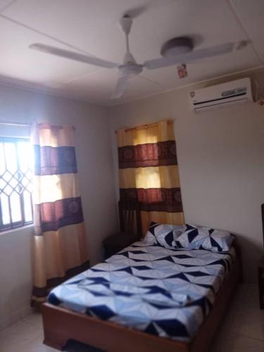 a bedroom with a bed and a ceiling at Spintex Villas - Available for Long Term Rentals in Ablekuma