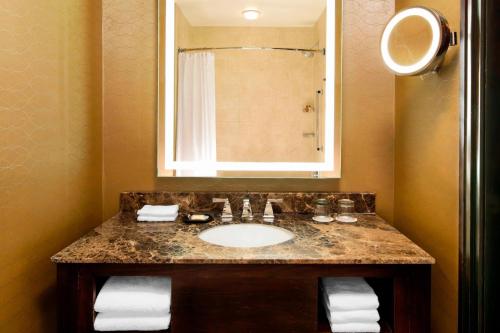 a bathroom with a sink and a mirror at Sheraton Orlando North in Orlando