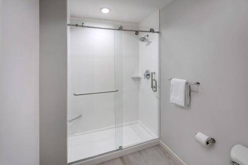 a shower with a glass door in a bathroom at Sheraton Orlando North in Orlando
