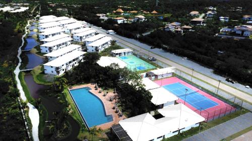 an aerial view of a resort with two swimming pools at Apartamento Vila do Lago in Mata de Sao Joao