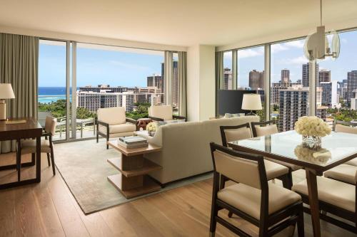 a living room with a couch and a table and chairs at The Ritz-Carlton Residences, Waikiki Beach Hotel in Honolulu