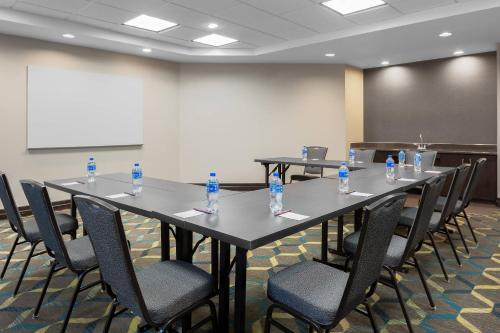 a conference room with tables and chairs with bottles of water at Residence Inn by Marriott Houston Katy Mills in Katy