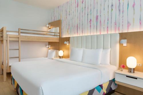 a bedroom with a bed and a bunk bed at The Viv Hotel, Anaheim, a Tribute Portfolio Hotel in Anaheim