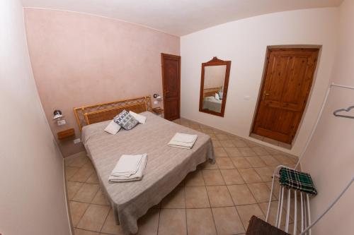 a bedroom with a bed with two towels on it at Agriturismo Al Cappero in Malfa