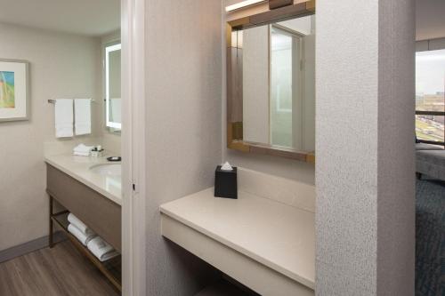 a bathroom with a sink and a mirror at Sheraton Dallas Hotel by the Galleria in Dallas