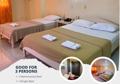 two beds in a hotel room with towels on them at La Elliana Hotel & Restaurant, Inc. in Laoag