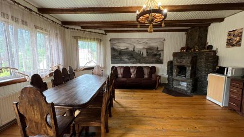 a dining room with a table and a couch at Arkan in Mykulychyn