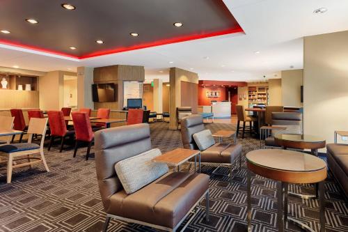 a hotel lobby with chairs and tables and a bar at TownePlace Suites by Marriott Charleston Mt. Pleasant in Charleston