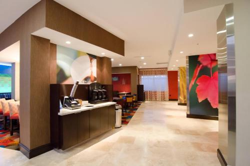 a lobby of a hotel with a reception desk at Fairfield Inn and Suites by Marriott North Spring in Spring