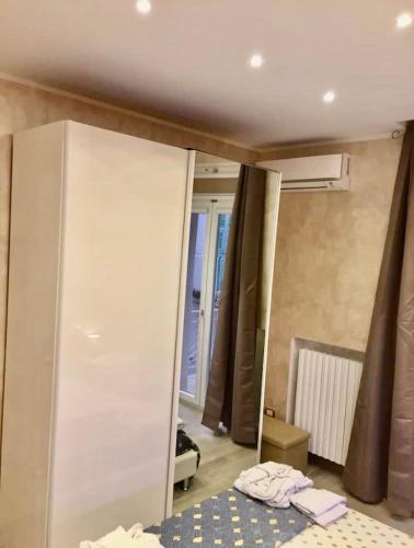a mirror in a room with a bed and a bedroom at Appartamento La Casa di Anna in San Severo