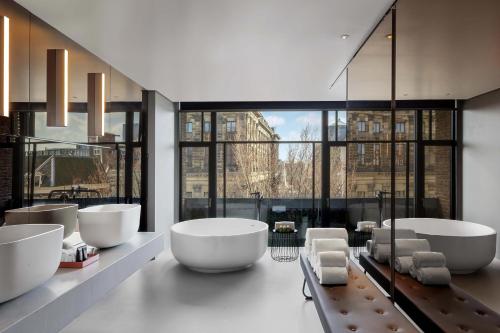 a bathroom with two sinks and two soaking tubs at W Amsterdam in Amsterdam