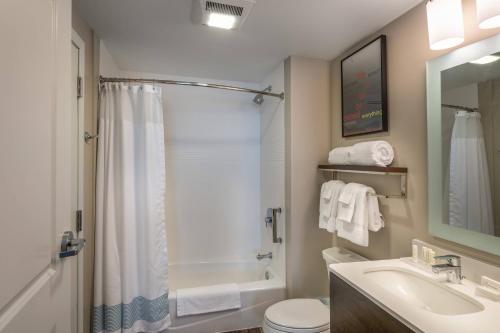 a bathroom with a shower toilet and a sink at TownePlace Suites by Marriott Milwaukee Oak Creek in Oak Creek