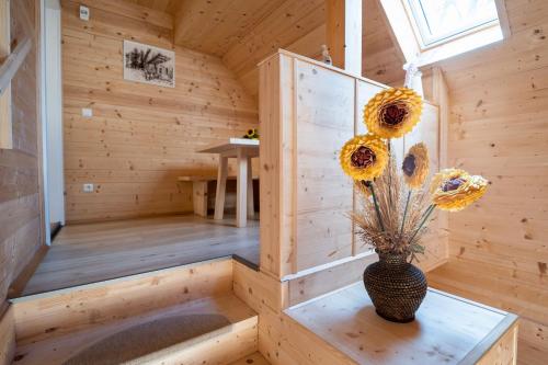 a wooden sauna with a vase with flowers in it at Schilcherland Lodge in Greisdorf