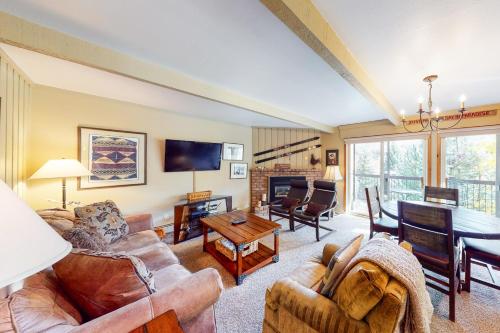 a living room with a couch and a table at Snowmas Village 20C in Snowmass Village