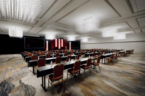 a conference room with tables and chairs and chandeliers at Chicago Marriott Oak Brook in Oak Brook