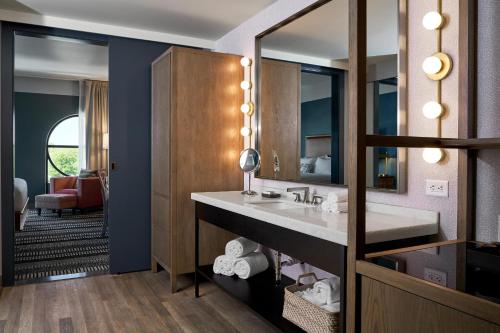 a bathroom with a sink and a mirror at The Memphian a Tribute Portfolio Hotel in Memphis