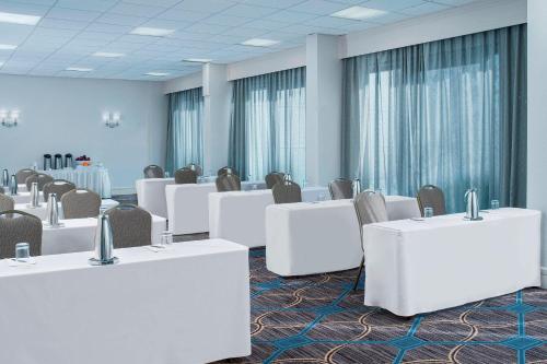 a conference room with white tables and chairs at Sheraton North Houston at George Bush Intercontinental in Houston