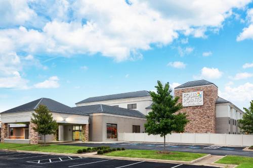 a rendering of the front of a hotel with a parking lot at Four Points Bentonville in Bentonville