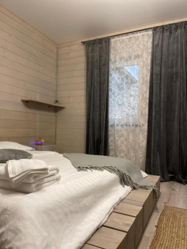 a bedroom with a large bed and a window at Sandal in Shaian