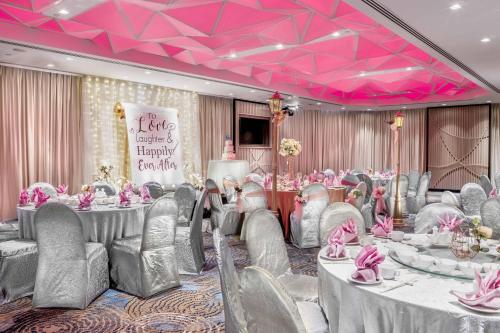 a banquet room with tables and chairs and pink ceilings at Four Points by Sheraton Singapore, Riverview in Singapore