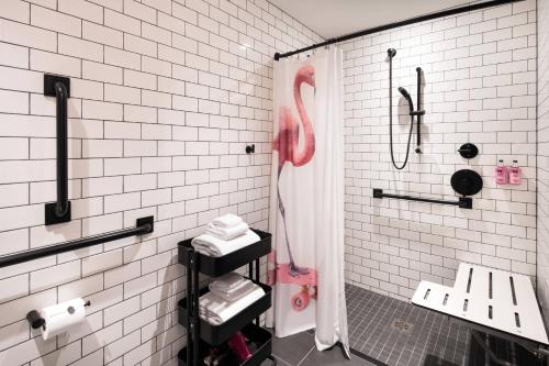 a bathroom with a pink flamingo in a shower at MOXY Seattle Downtown in Seattle