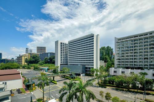 a city with two tall buildings and a street at Four Points by Sheraton Singapore, Riverview in Singapore